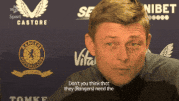 a man in front of a sign that says rangers