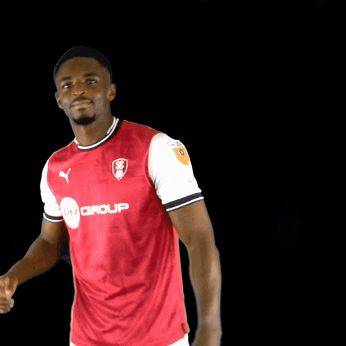 a man is wearing a red shirt with the word puma on it