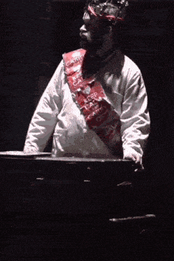 a man wearing a crown and a keep calm sash