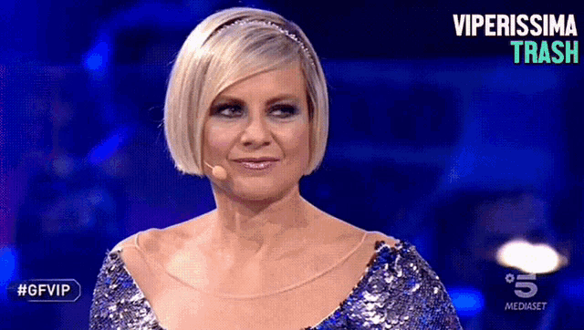 a woman stands in front of a microphone with the words viperissima track on the bottom