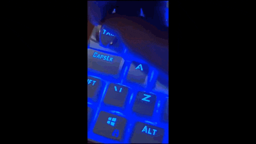 a close up of a purple keyboard with a person 's hand on it .