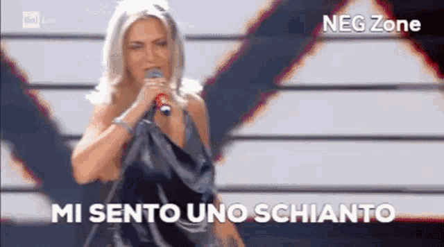 a woman singing into a microphone with neg zone written in the corner