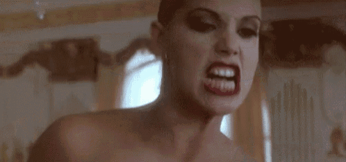 a close up of a woman 's face with the words `` fucker ! fuck off '' written on it .