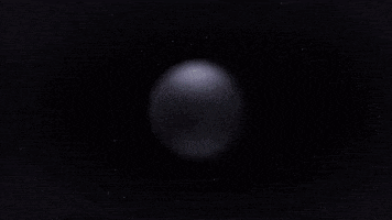 a sphere of water splashing on a black surface