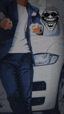 a man in a suit is pointing at a troll face