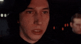 a close up of a man 's face in a dark room with a blurred background .