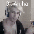 a man wearing headphones is making a funny face while playing a video game .