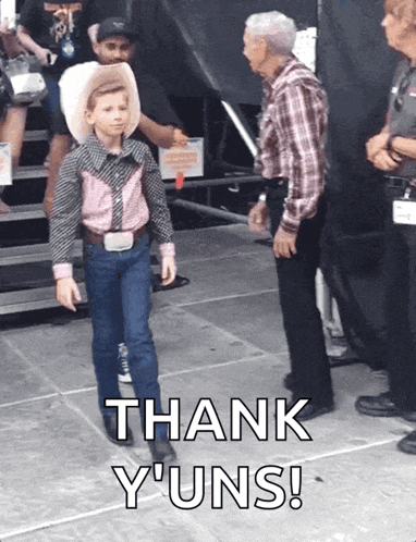 a young boy in a cowboy outfit is standing next to a man with the words thank y'uns on the bottom