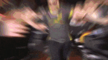 a blurry picture of a person 's torso with a purple background