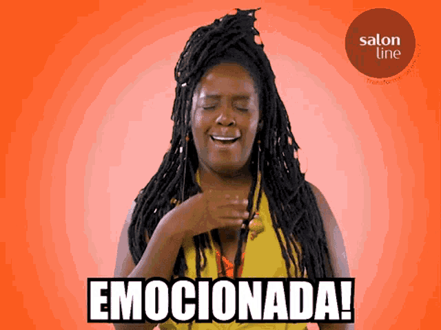 a woman with dreadlocks says emocionada in front of a salon line advertisement