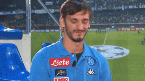 a man wearing a blue polo shirt with the word lete on it