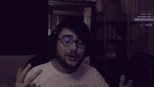 a man wearing glasses and a shirt that says ' i 'm a x102 ' on it