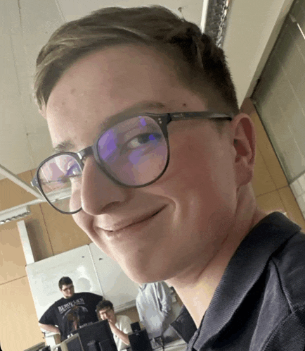 a young man wearing glasses and a shirt that says burbank