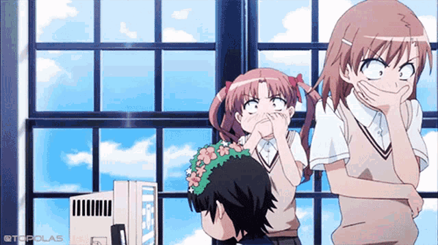 a girl with a flower in her hair is covering her mouth while another girl looks surprised