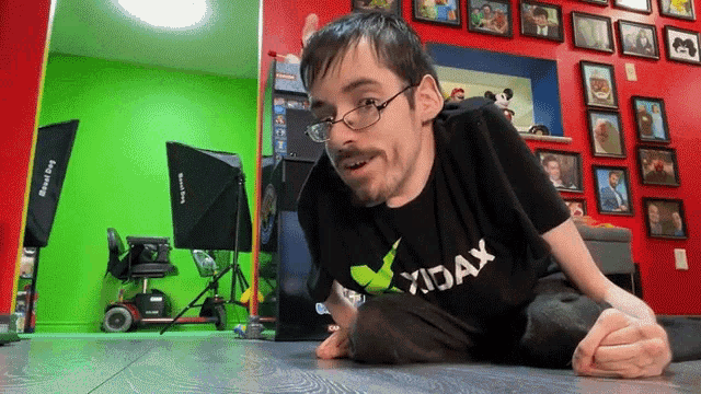 a man wearing glasses and a shirt that says xjax