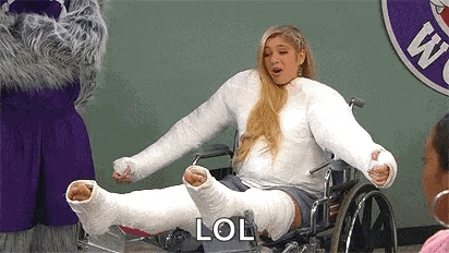 a woman with a cast on her leg is sitting in a wheelchair and saying lol .