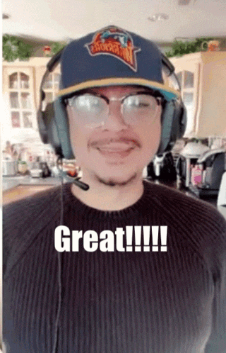 a man wearing headphones and a hat with the word great on it