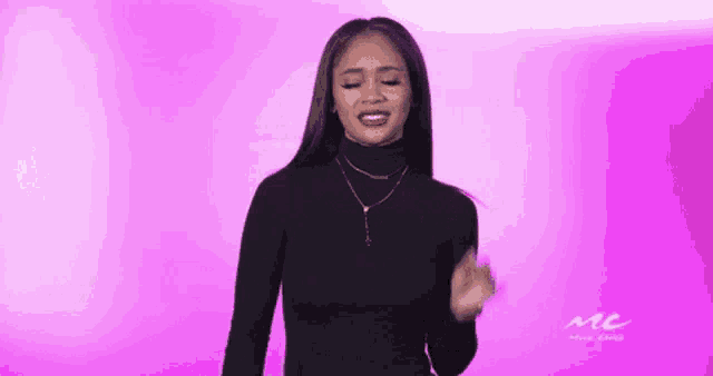 a woman in a black turtleneck sweater is making a funny face .