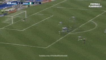 a soccer game is being played on a field with a goalie diving to save a ball .