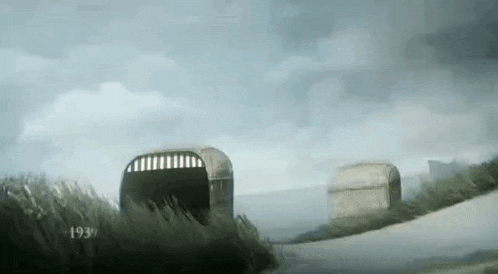 a couple of bunkers are sitting on the side of a road .