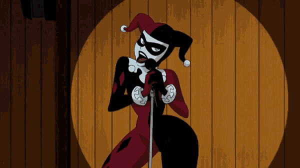 harley quinn is singing into a microphone in front of a wooden background