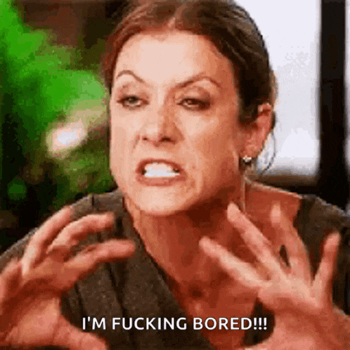 a woman is making a funny face and says i 'm fucking bored !
