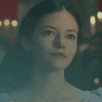 a close up of a young woman 's face in a dark room .