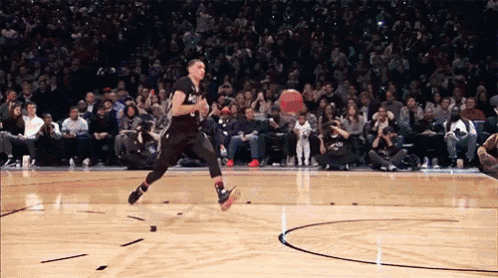 a basketball player is jumping in the air while wearing a black jersey with the number 1 on it