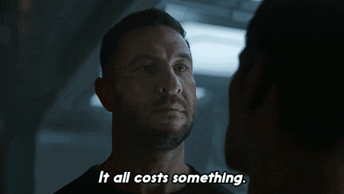 a man says " it all costs something " while looking at another man