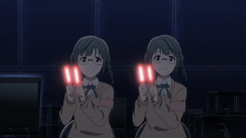 two anime girls are holding glowing red lights in their hands