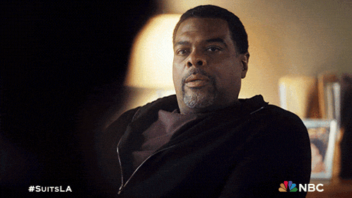 a man sitting in a dark room with a nbc logo on the bottom right