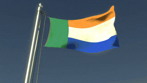 a green orange white and blue flag is flying in the wind