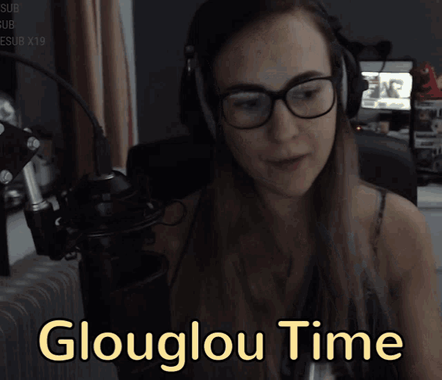 a woman playing a flute in front of a microphone with the words glouglou time written below her