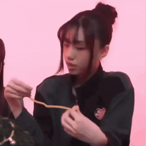 a girl is holding a rope in her hands and making a face .