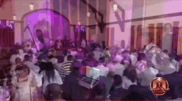 a large crowd of people are gathered in a church for a concert
