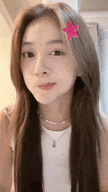 a woman with long hair and a pink star in her hair
