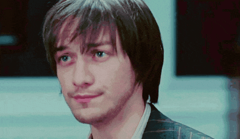 a close up of a man 's face with blue eyes