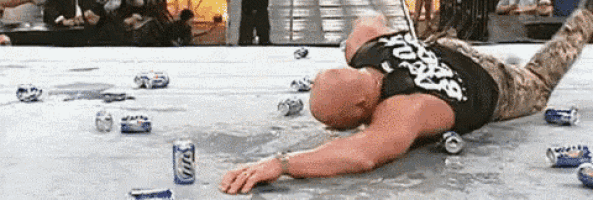 a wrestler is laying on the ground surrounded by empty bud light cans .