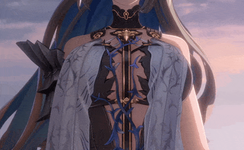 a close up of a woman 's torso with a blue and black floral design