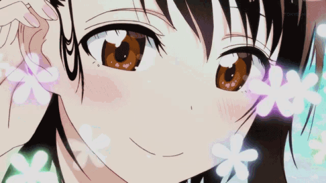 a close up of a girl with flowers around her ear