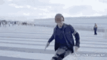 a man in a military uniform is running on a snowy road .