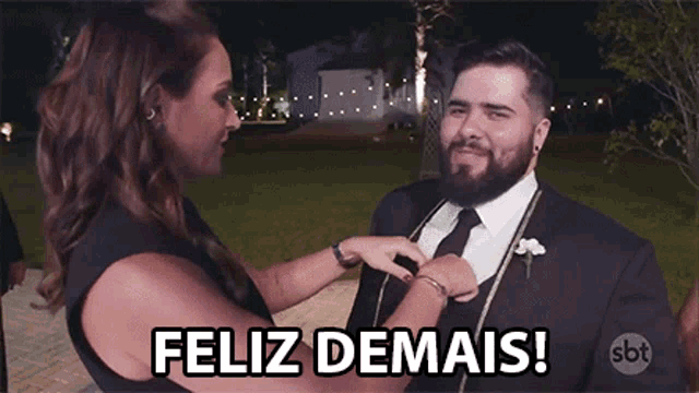 a man in a suit is being helped by a woman with the words feliz demais below him