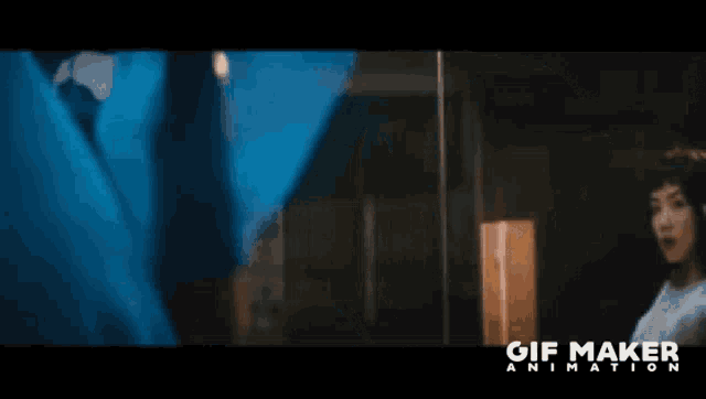 a woman wearing headphones looks at herself in a mirror with the words gif maker animation visible