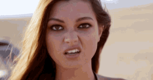 a close up of a woman making a face