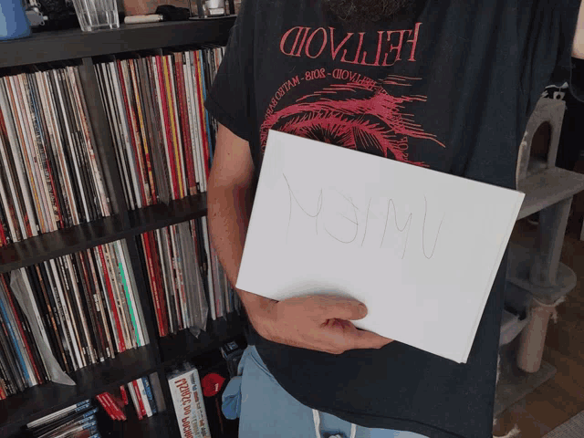 a man holding a piece of paper that says ' almost ' on it