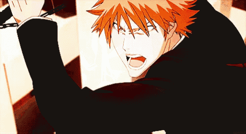 a man with orange hair is holding a chain in his hand and shouting .