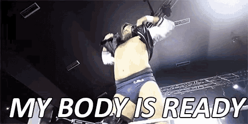a man in a wrestling ring with the words `` my body is ready '' written on the screen .