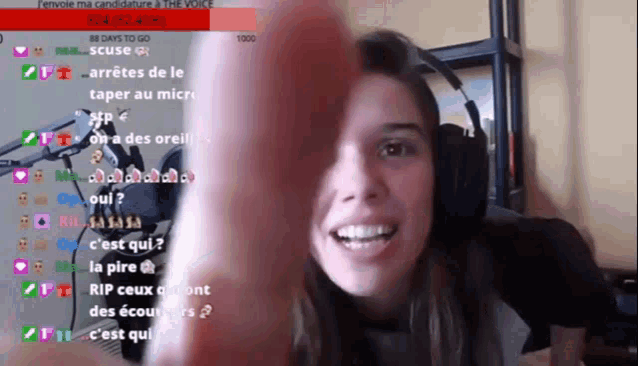a woman wearing headphones is smiling in front of a screen that says 88 days to go 1000