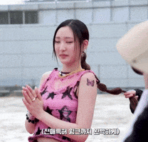 a woman in a pink top has a butterfly tattoo on her shoulder