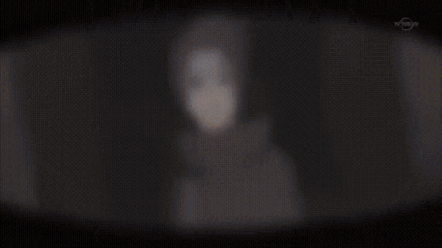 a close up of a person 's face with a tv channel visible in the corner
